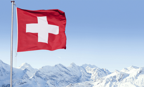 Swiss flag flying over the mountains